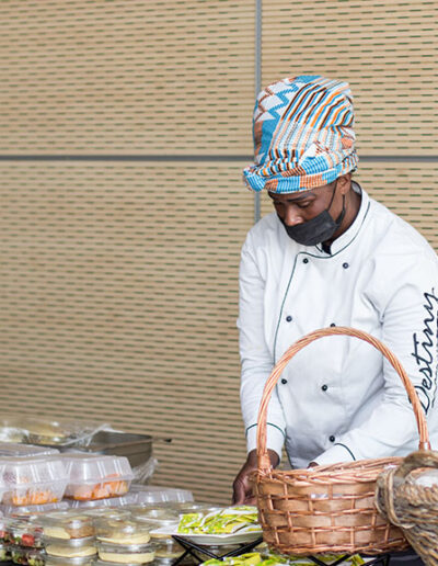 Chef arranging individually packaged meals for express meal delivery and efficient corporate catering service