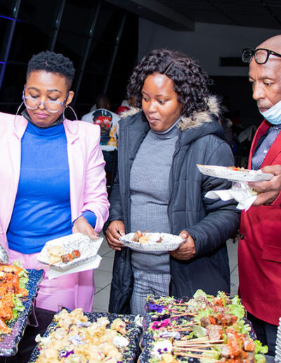Guests serving themselves from a variety of appetizing foods at a corporate catering buffet