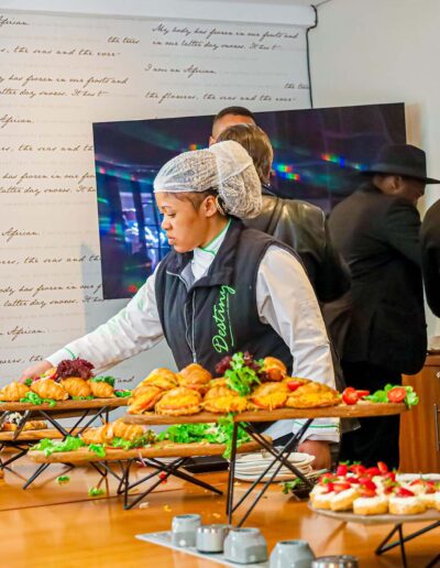 Chef preparing a spread of delicious catered food items at Destiny Cuisine event