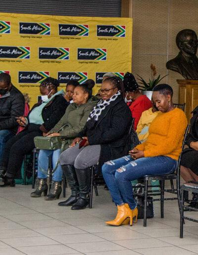 Guests seated at an indoor function supported by South African branding, indicating national partnerships and large-scale catering coordination