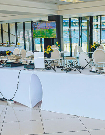 Woman selecting food from catered buffet table at Destiny Cuisine event