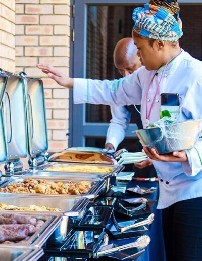 Guests serving themselves from a variety of appetizing foods at a corporate catering buffet