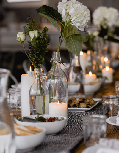 Elegant dining table with candles and flowers set for a formal event or dinner