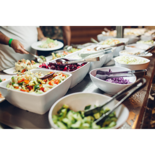 Assorted salads and vegetables presented in serving bowls, showcasing healthy dining for workplace canteen services